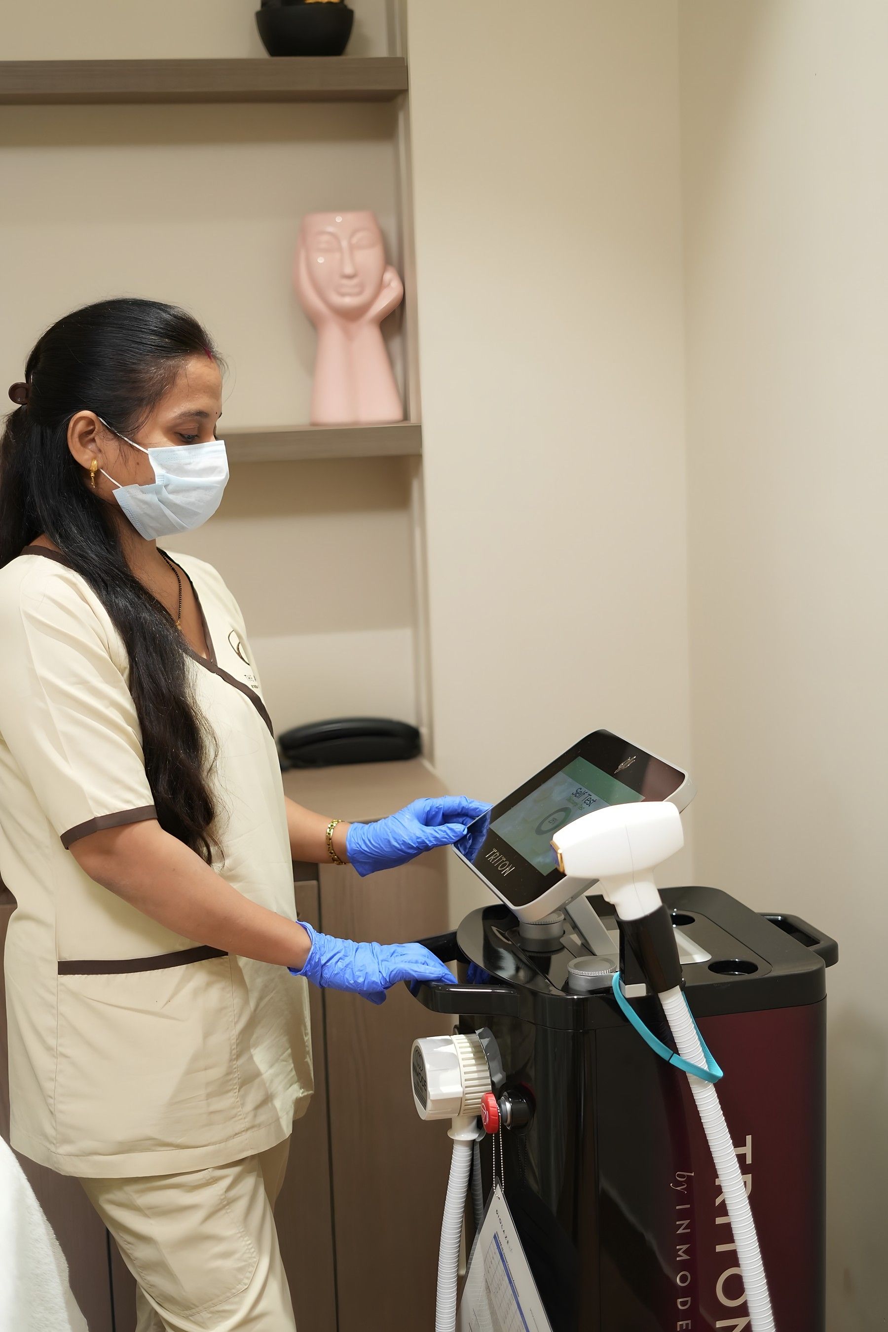 Therapist preparing a laser system for treatment at The Asense